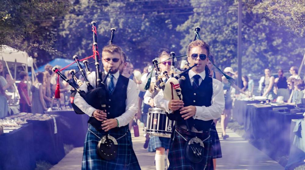 bagpipers marching to scotland yard during homecoming events